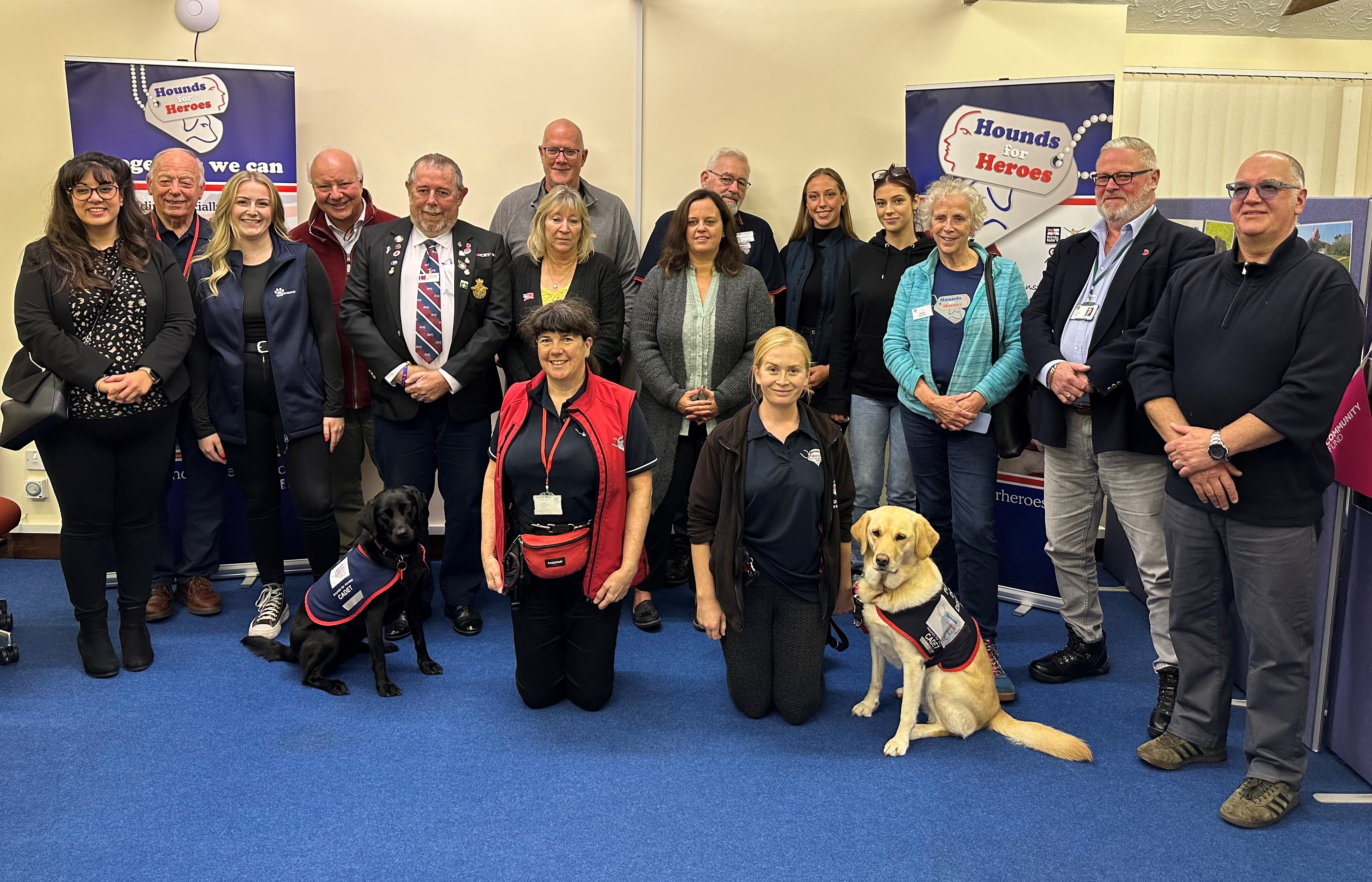 A group of our supporters with two assistance dogs at the front.