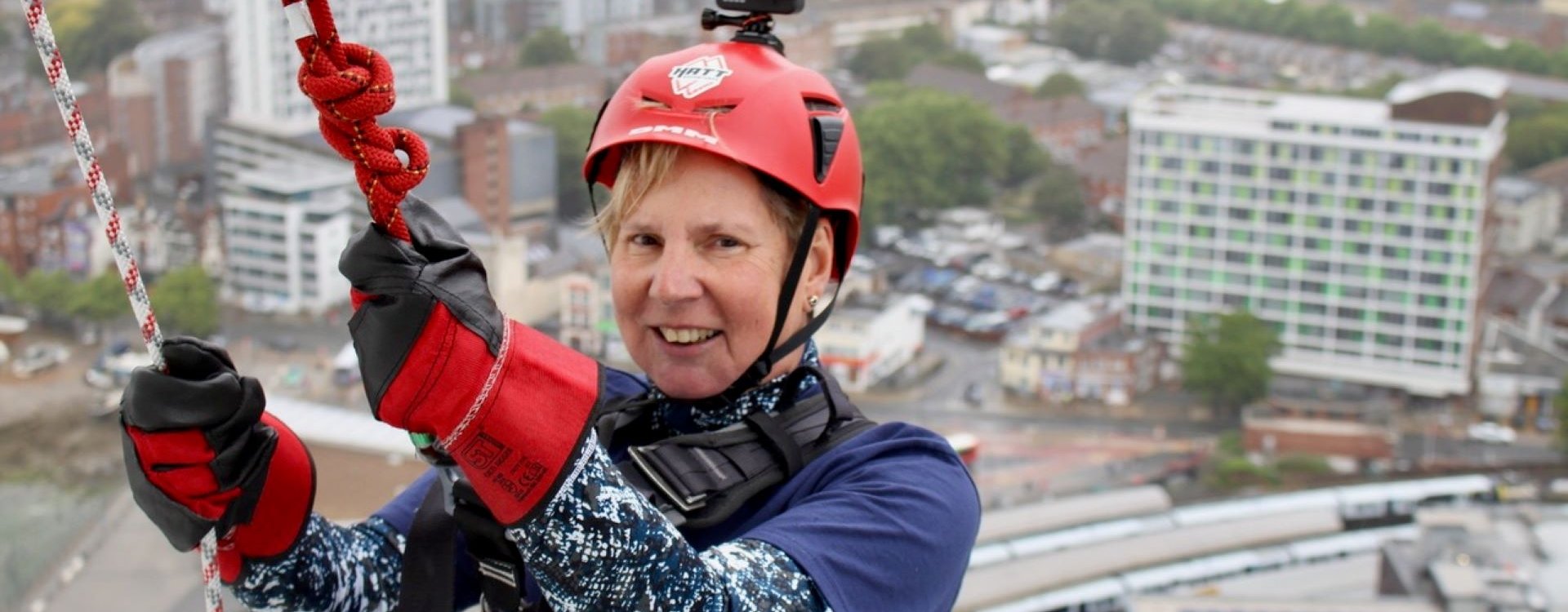Lady completing an abseil of the Spinnaker Tower.
