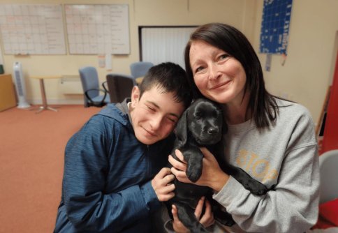 Hounds for Heroes Puppy Parent volunteer with puppy